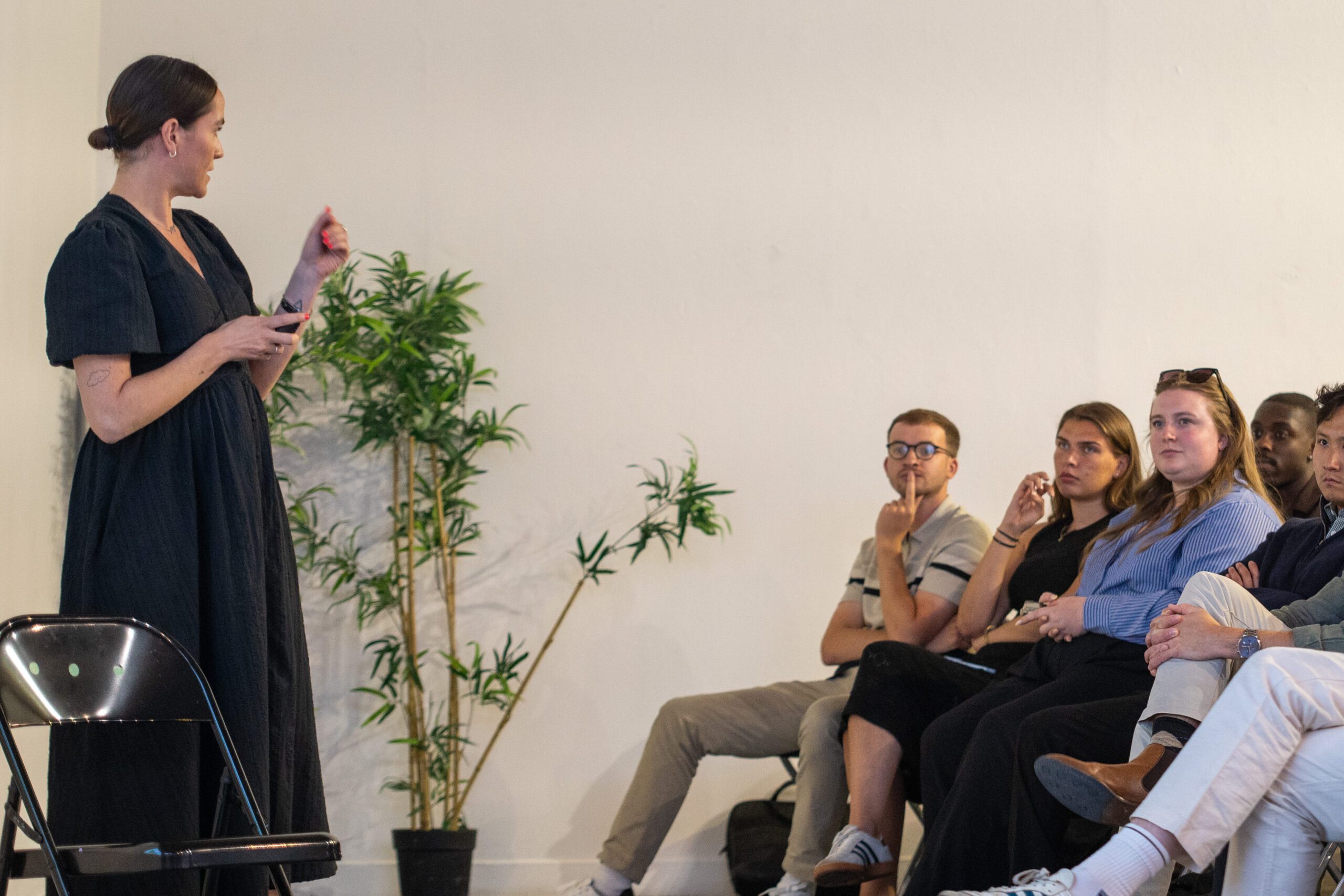 Clare Cooper, UK MD of Levin, is presenting to a crowd in a London gallery. 